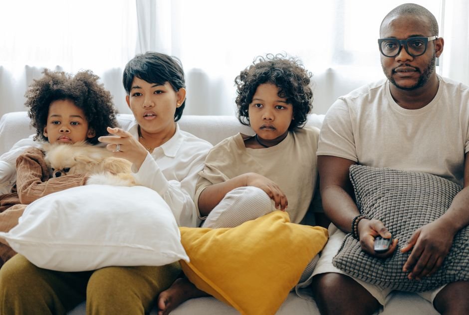 A family watching live TV together at home