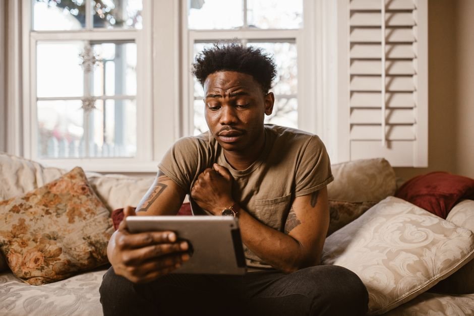 Person watching live TV on an Android tablet at home