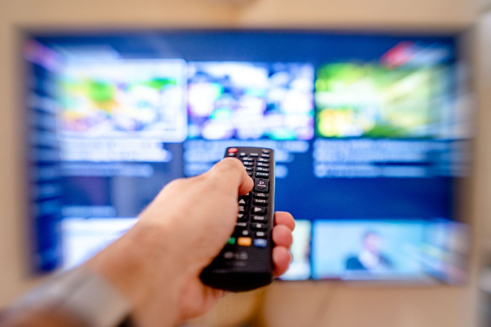 Pointing a remote at a smart TV menu to check playback after logging in to an IPTV player